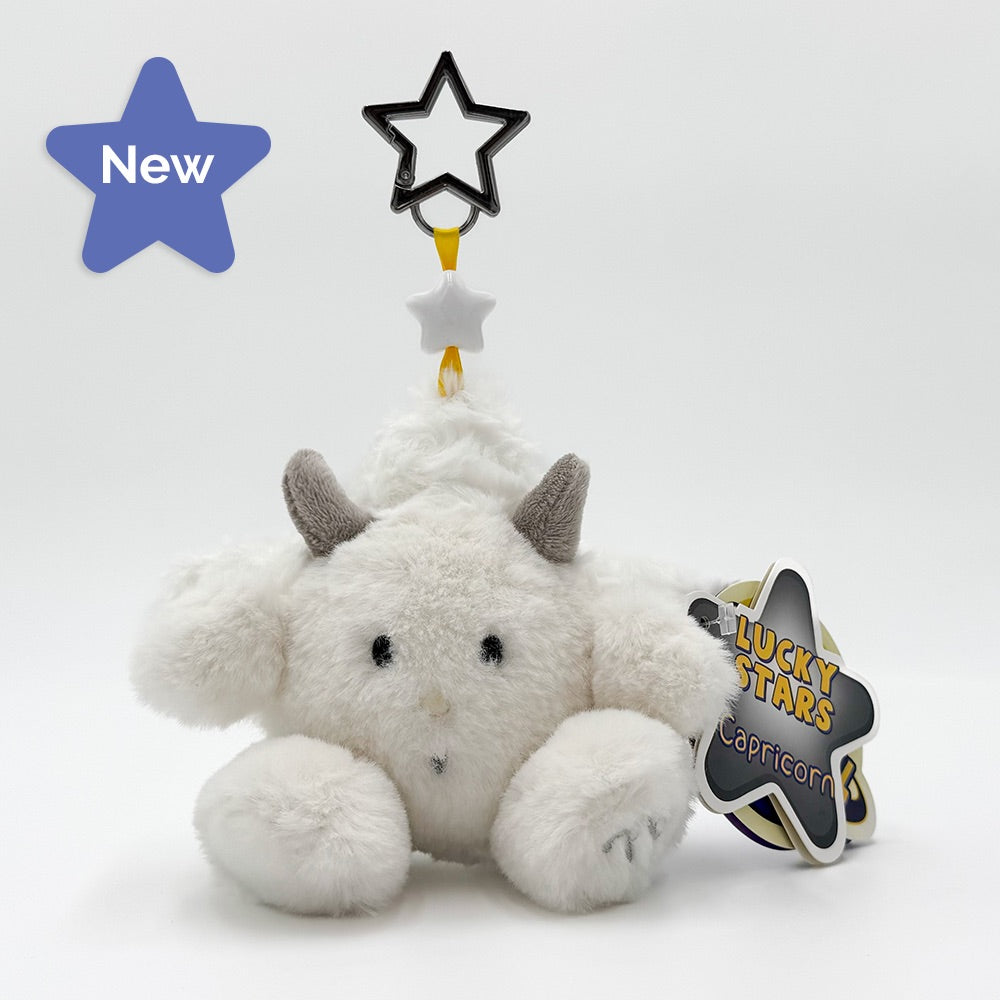 A white plush keychain with gray horns and a black-and-white star topper, shown on a clean white background with a hang tag that reads 'Lucky Stars Capricorn'.