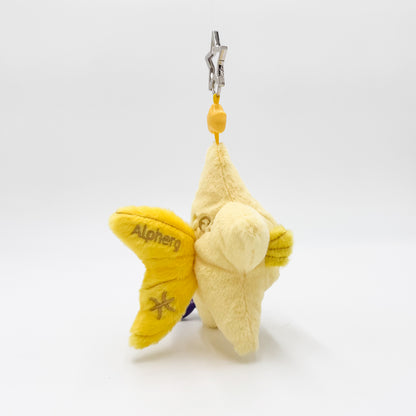 A plush star-shaped keychain charm in pale yellow and bright yellow, featuring the embroidered name 'Alpherg' and a star symbol on its wing, attached to a silver metal clasp with a yellow bead.