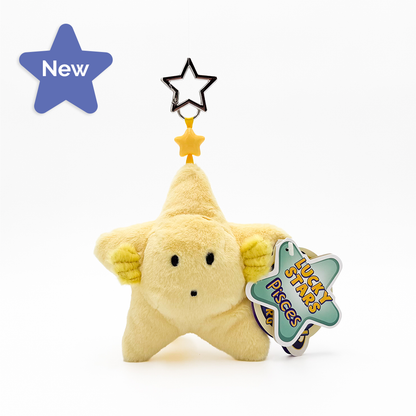A pale yellow plush star-shaped keychain or bag charm with a simple face, attached to a star-shaped ring. A paper tag on the side reads 'LUCKY STARS Pieces'.