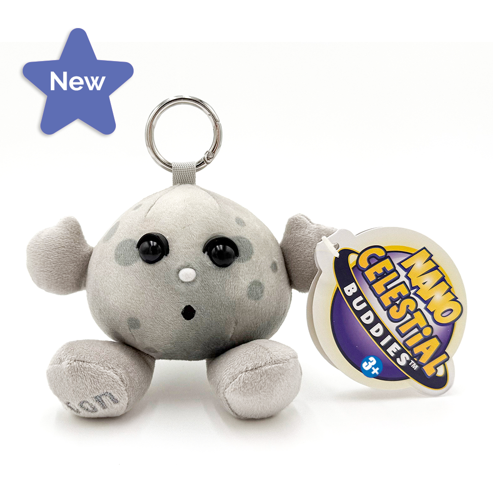 A plush  keychain shaped like moon   with black eyes and a metal key ring, shown on a white background with a round product tag reading 'Nano Celestial Buddies' and a pink 'New In' banner in the top left.